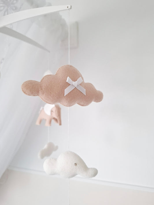 Side view of neutral elephant mobile featuring floating white clouds and soft detailing for a calm and dreamy nursery space.