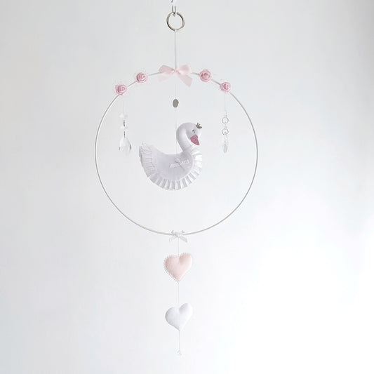 Curated swan wall charm in soft pink and white, featuring a crown, roses, and delicate hanging hearts.