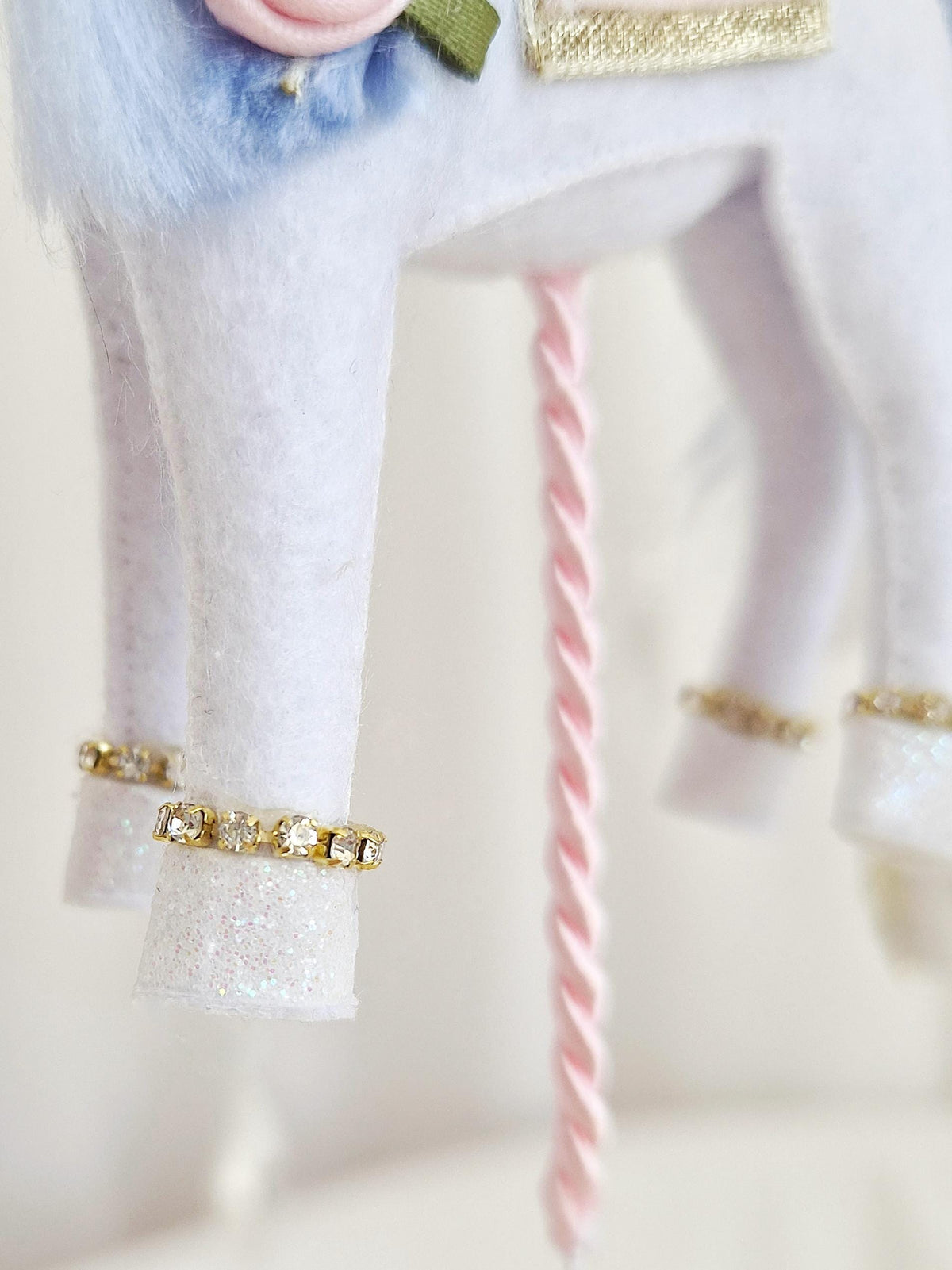 Close-up of the handmade felt horse legs with glitter hooves, gold trim and twisted hanging cord.