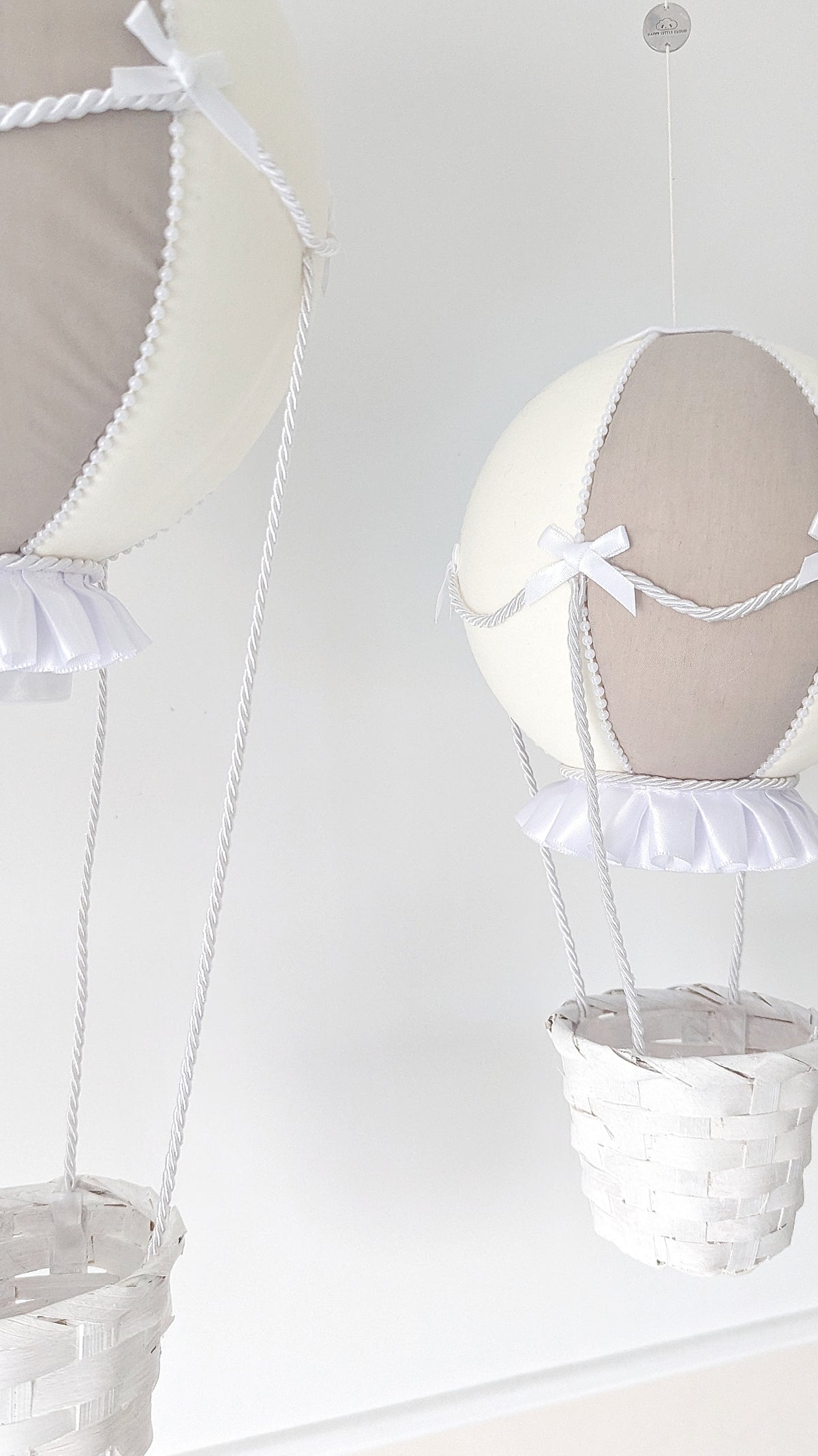 Elegant large hot air balloon in ivory and taupe with pearl trim, satin frills and a soft white basket.