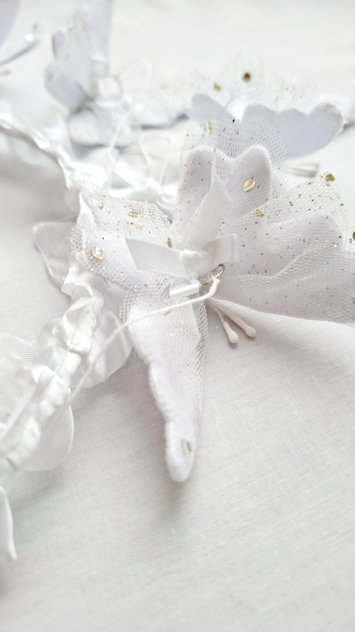 Luxury handcrafted baby mobile with layered white butterflies and intricate lace details, perfect for high-end baby spaces.
