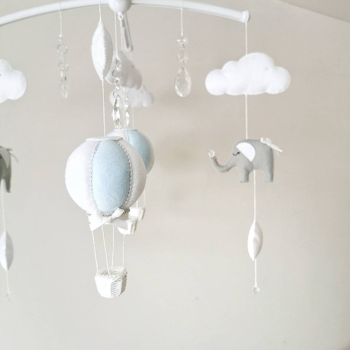 A gentle mobile in soft blue and white tones styled for a baby boy’s nursery perfect for gifting or adding quiet charm