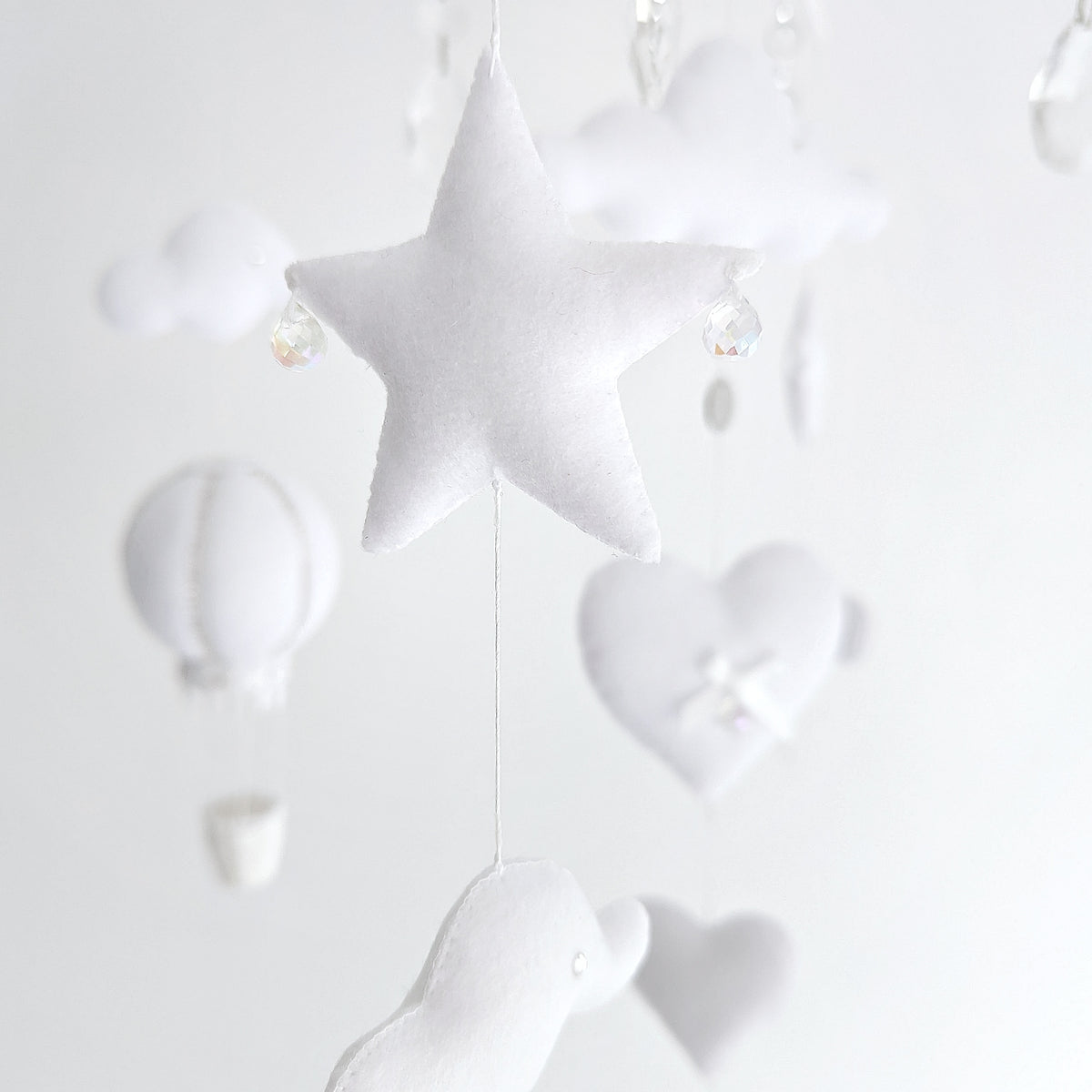 Balloon-themed luxury mobile in soft white, designed with clouds, hearts, and a timeless aesthetic.