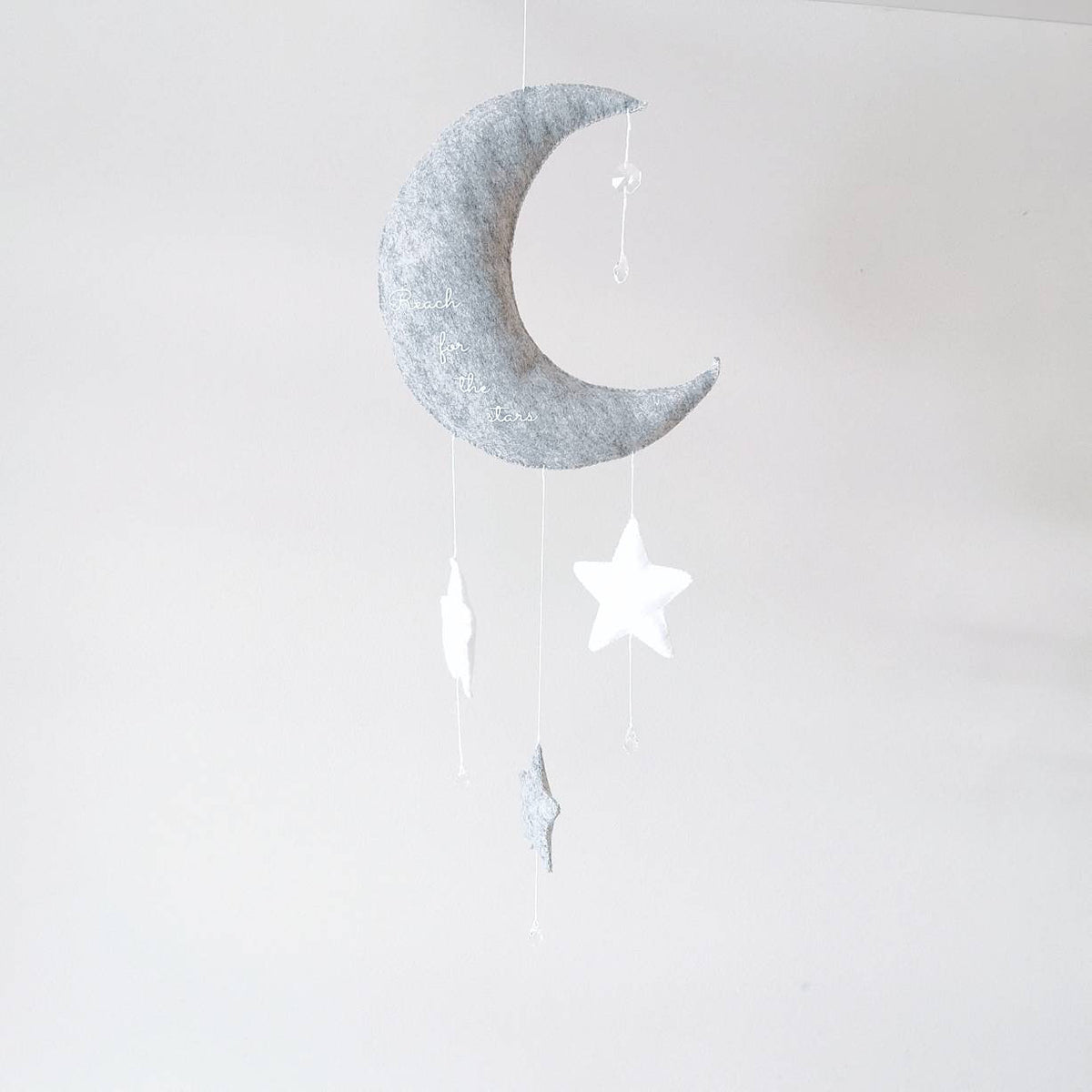 Crescent moon nursery wall décor with hanging stars—lovely as a gift for a christening or new arrival.