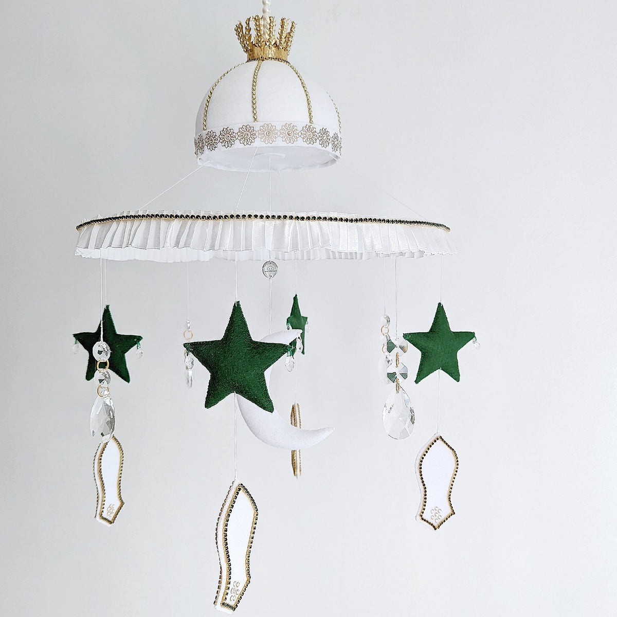 Eid nursery decor featuring felt stars, mosque shapes, crystal accents, and the symbolic sandal of the Prophet Muhammad (pbuh).

