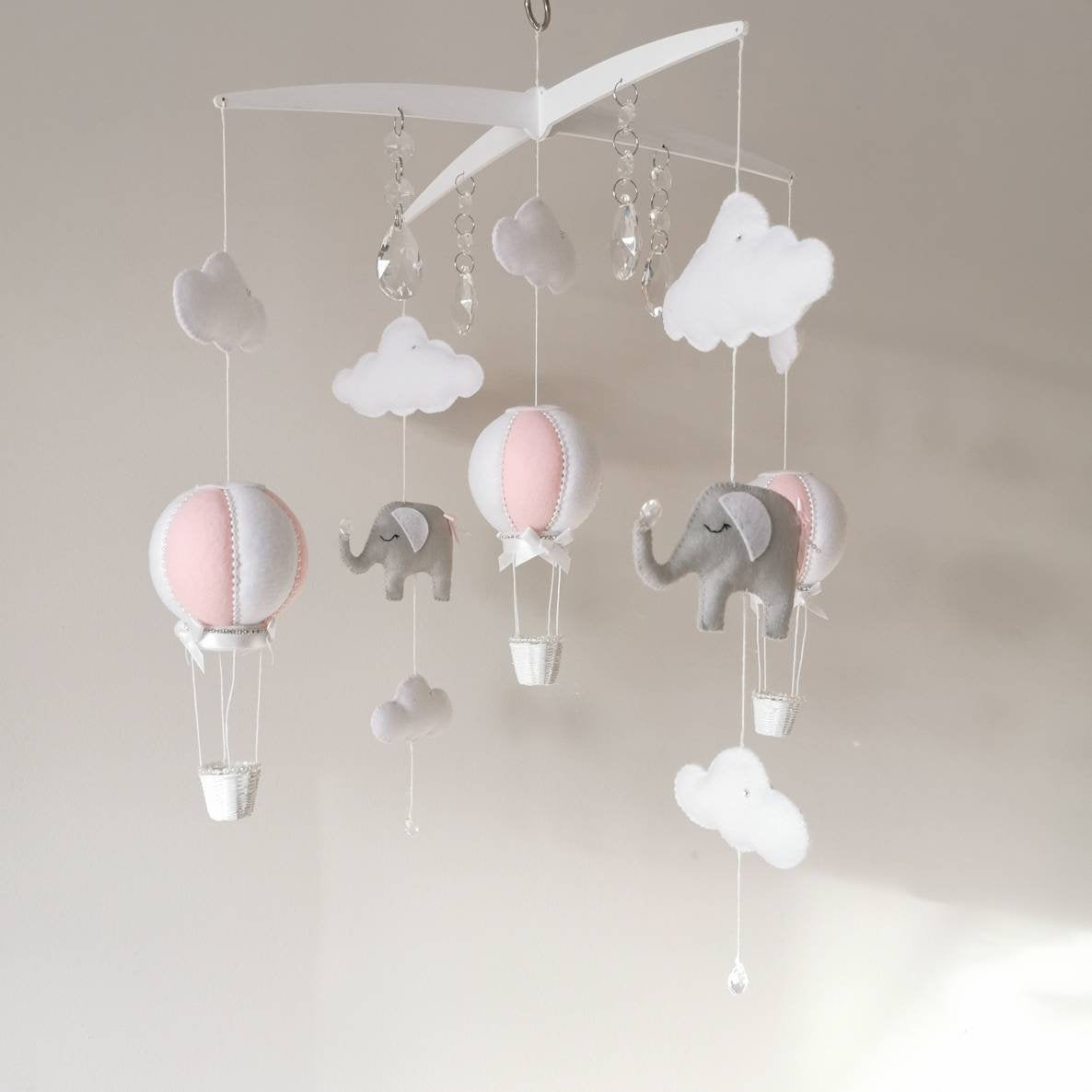 Close-up of a soft felt elephant with delicate stitching a peaceful little companion for a lovingly crafted baby mobile

