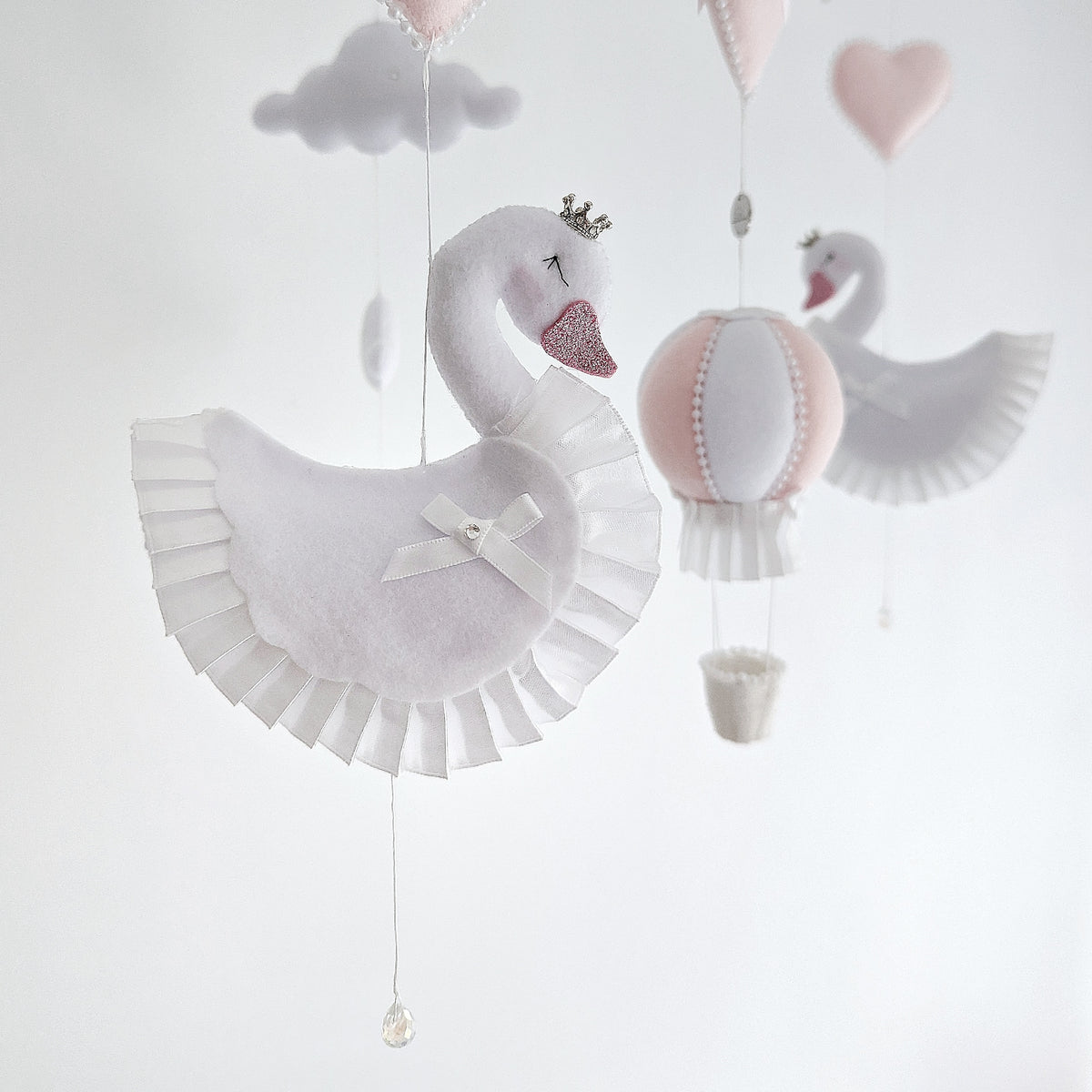 Handcrafted swan mobile with cloud and heart details, perfect for a serene and graceful nursery