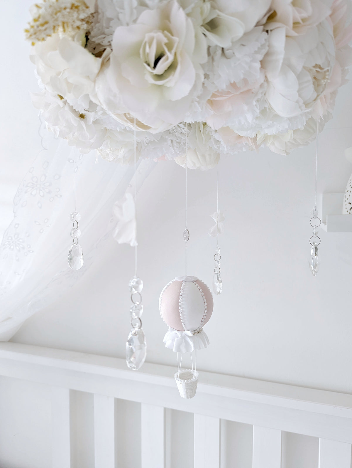 Handcrafted baby mobile with lifelike roses, hydrangeas, and a single hot air balloon, creating a dreamy floral crown look.