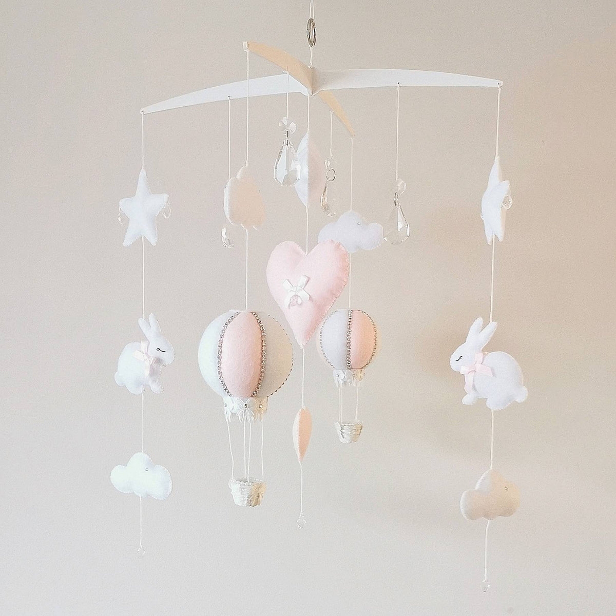 Heirloom-quality baby mobile for girls featuring a bunny, hot air balloon, and pastel felt hearts.