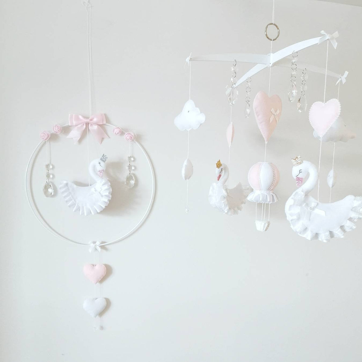 Heirloom swan baby mobile with delicate florals and heart accents, perfect for a dreamy girl's nursery.