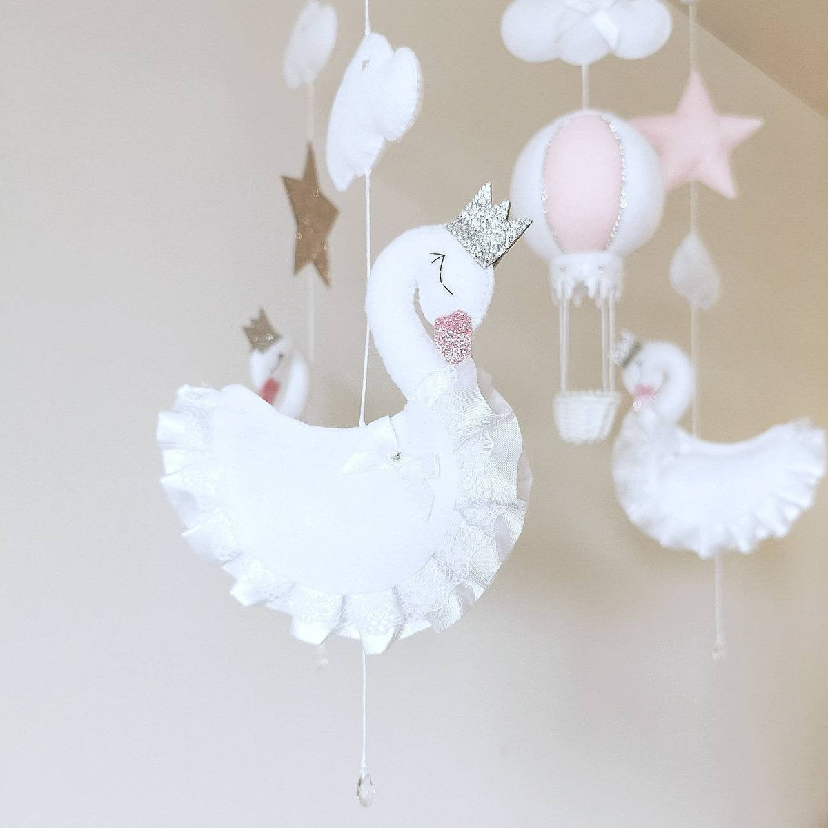 A dreamy view of elegant swans and soft shapes dancing above, perfect for adding a floating fairytale touch to nursery decor