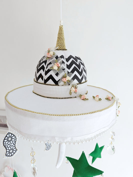 Muslim baby mobile with a black and white patterned mosque dome, crystal drops, and the Sandal of the Prophet Muhammad (pbuh).