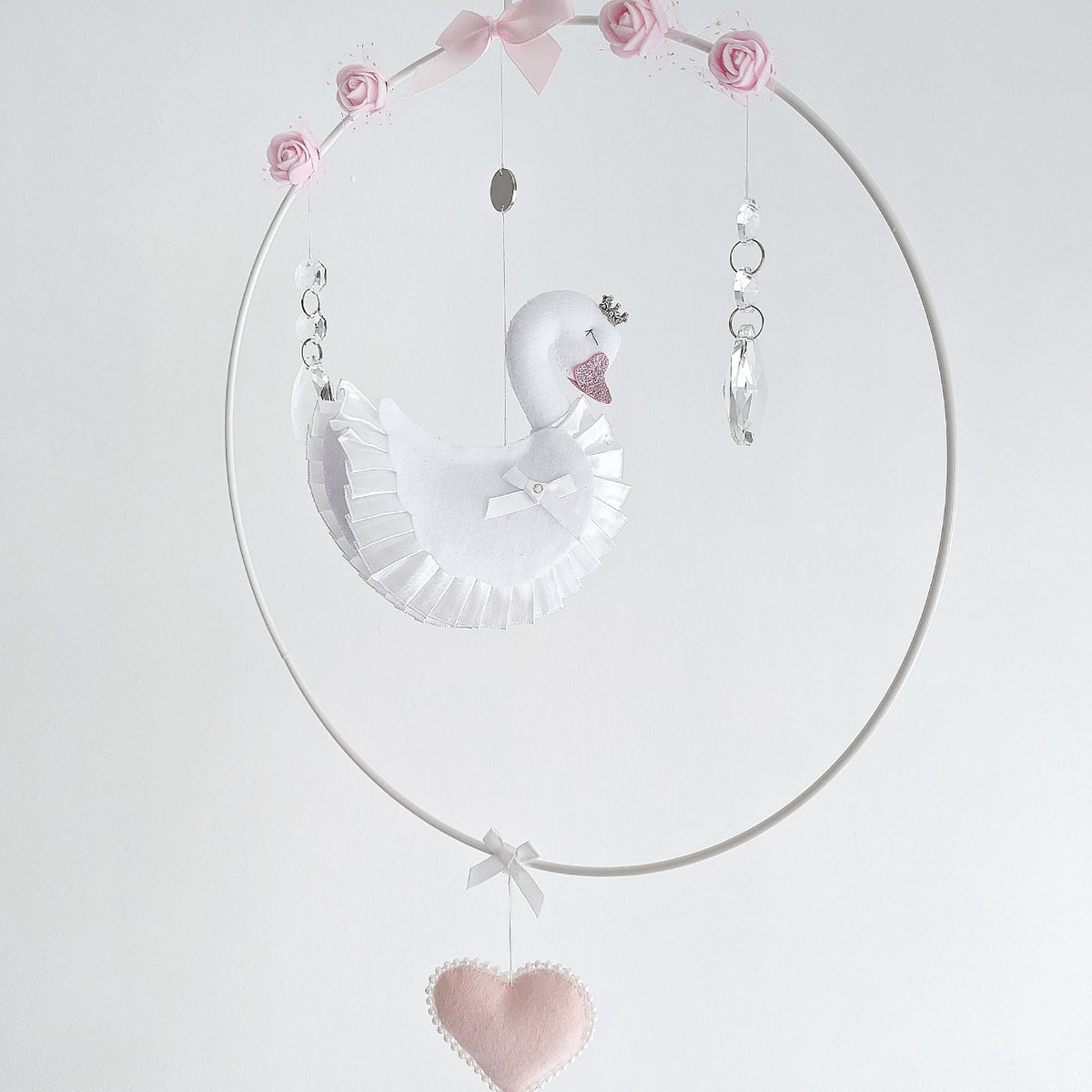 Personalised swan wall charm featuring baby’s name on soft felt heart, luxury handcrafted keepsake for baby showers or christenings.

