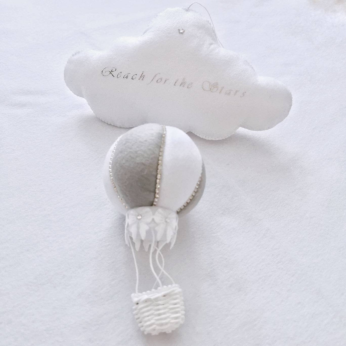 elegant felt cloud with “Reach for the Stars” embroidery and a handcrafted white and grey hot air balloon. Baby Gift